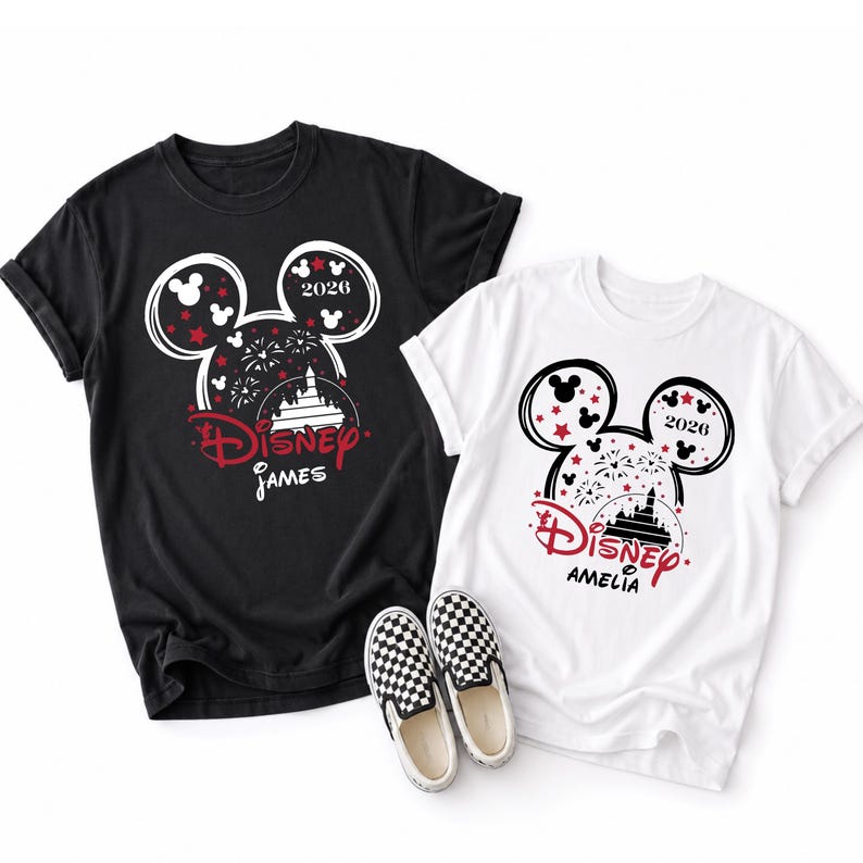 May include: Two t-shirts, one black and one white, featuring a Mickey Mouse head design with the text "Disney" and a castle graphic. The black shirt says "James" and the white shirt says "Amelia". Checkered slip-on shoes are in the foreground.