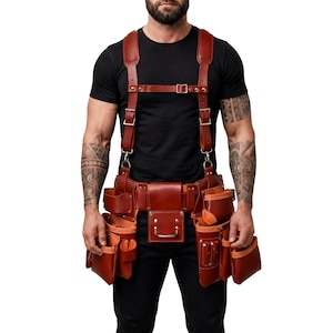 May include: A brown leather tool belt with multiple pouches and pockets, featuring a matching leather harness with adjustable metal buckles and clips. The belt is designed with reinforced stitching and includes various compartments for organizing tools.