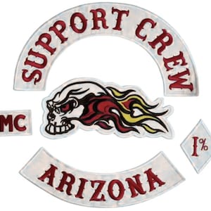 May include: A set of embroidered patches featuring a white arched top rocker with red text reading SUPPORT CREW, a white bottom rocker with red text reading ARIZONA, a rectangular MC patch, a diamond 1% patch, and a skull with red and yellow flames.