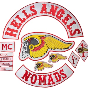May include: A collection of embroidered patches featuring a large white arch with red text reading HELLS ANGELS, a central winged skull emblem, a white arch with red text reading NOMADS, smaller patches with text including MC, AFFA, and 666, and diamond-shaped 1% patches.