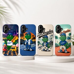 May include: Four phone cases featuring a green dinosaur mascot wearing a baseball cap and uniform. Each case has a different background, including fireworks, a stadium, and the words "Los Angeles". The cases are in various colors.