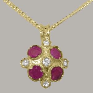 May include: A gold pendant necklace with a cluster of five ruby stones and four smaller diamond stones. The pendant is in the shape of a flower.