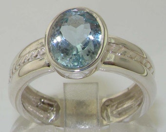 May include: A silver ring with a light blue oval gemstone. The ring band has a braided design.