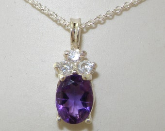 May include: A silver necklace with a purple amethyst gemstone pendant surrounded by four smaller clear gemstones.