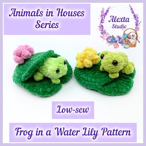 May include: Two crocheted green frogs resting on dark green lily pads. One frog is under a green leaf with a pink flower, and the other sits next to a yellow flower. Text reads: Animals in Houses Series, Low-sew, Frog in a Water Lily Pattern.