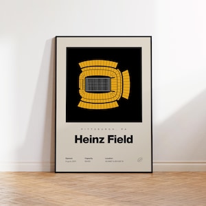 May include: A framed poster featuring a top-down yellow and black graphic of Heinz Field in Pittsburgh, PA. The print includes the text Heinz Field, location coordinates, opening date of August 2001, and a capacity of 68,400 on a cream background.