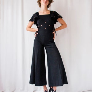 1970s black crepe flared leg jumpsuit with ruffled sleeves // Vintage 70s hippie bell bottom palazzo overalls image 1