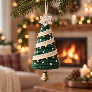 May include: A cone-shaped, dark green crocheted Christmas tree ornament featuring a cream-colored crocheted snowflake topper, spiraling cream ribbon trim, small white pearl beads, and gold metallic spheres, finished with a brass bell at the base.