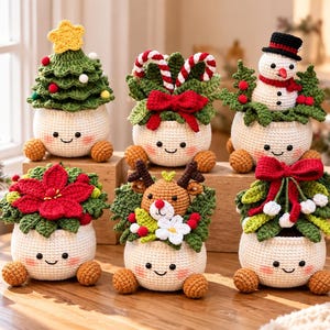 May include: Six crocheted cream-coloured pots with smiling faces and brown feet, each topped with festive holiday decor including a Christmas tree, candy canes, a snowman, a red poinsettia, a reindeer, and mistletoe with a large red bow.