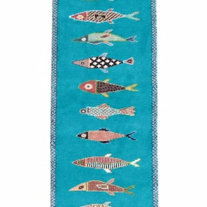 May include: A rectangular runner rug featuring a vibrant turquoise background with a vertical row of twelve stylized fish. Each fish displays a unique pattern, including geometric shapes, stripes, and solid colors in shades of red, brown, and green.