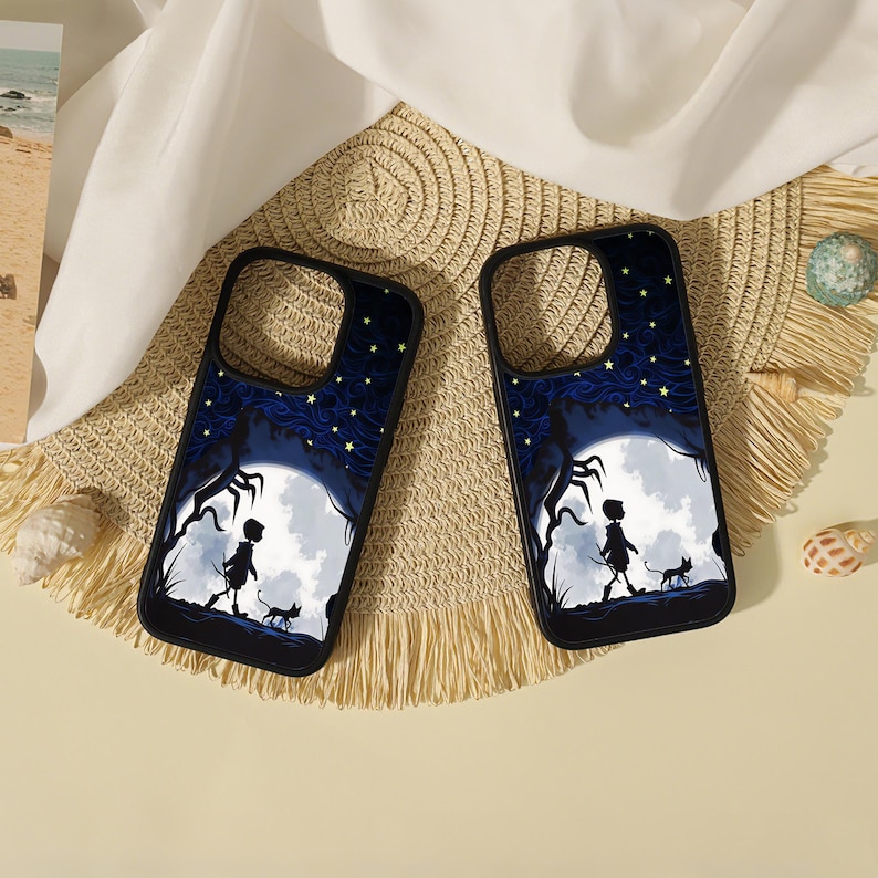 May include: Two black smartphone cases featuring a graphic illustration of a silhouette of a person and a small cat walking under a large white moon against a dark blue starry sky with swirling patterns and dark tree branches on the sides.