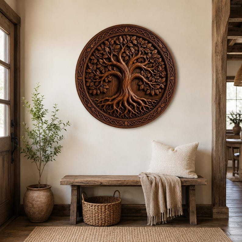 May include: A circular wooden wall art piece featuring a detailed relief carving of a tree with intricate roots and foliage. The design is enclosed within a decorative border with a woven pattern, showcasing a rich brown wood grain finish.