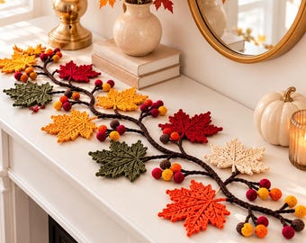 May include: A crochet garland featuring dark brown vines adorned with multi-colored maple leaves in shades of red, orange, yellow, green, and cream, interspersed with small, round, textured berries in matching autumn colors.