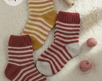 May include: Three knitted socks with ribbed cuffs and horizontal stripes in mustard yellow, maroon, and light gray. The socks are arranged with small balls of yarn. A circular white label in the upper left corner contains the text pattern Only.