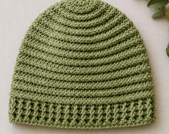 May include: A sage green crochet beanie featuring a textured ribbed stitch pattern throughout the main body and a distinct vertical post stitch design along the bottom edge, creating a structured and uniform appearance for this headwear piece.