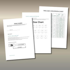 May include: Three white sheets of paper with ring sizing information. One sheet is a ring sizer with a 3.5-inch ruler. Another sheet is a ring size chart. The third sheet is a size chart with ring sizes from 4.5 to 13.