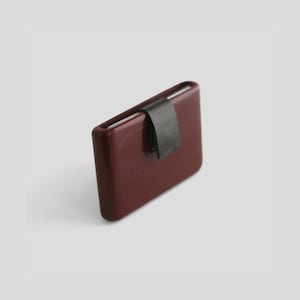 May include: A set of three ceramic mugs with a speckled, matte finish. The mugs are in shades of cream, light gray, and dark gray. Each mug has a simple, minimalist design and a rounded handle.