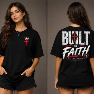 May include: A black short-sleeve t-shirt featuring a small red cross and white crown graphic on the front left chest. The back displays the white text BUILT BY FAITH with a red cross, a small heart with a cross, and the verse 2 CORINTHIANS 5:7.