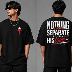 May include: A black short-sleeve t-shirt featuring a small red cross and white crown graphic on the front chest. The back displays the white and red text "NOTHING CAN SEPARATE ME FROM HIS love" with a small cross inside a heart and "ROMANS 8:38-39".