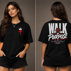 May include: A black short-sleeve t-shirt featuring a small red cross with a white crown graphic on the front left chest. The back displays the text WALK IN PURPOSE in large white letters, a red cross, and smaller text including GOD PURPOSE FAITH DESTINY.