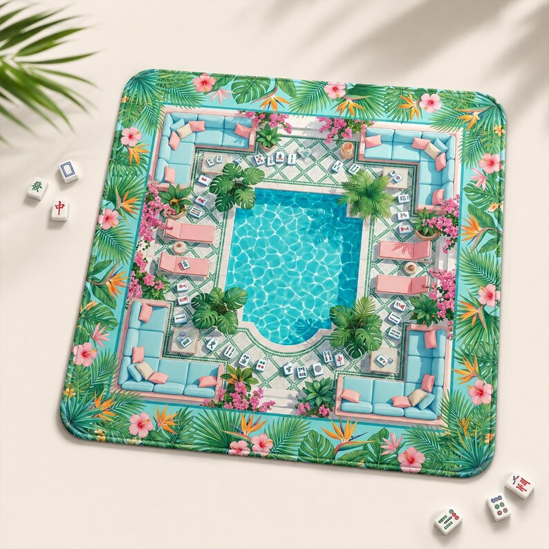 May include: A square game mat featuring a vibrant tropical pool scene with light blue lounge furniture, pink cushions, and lush green palm leaves. The border is decorated with hibiscus and bird of paradise flowers. Several white mahjong tiles are scattered.