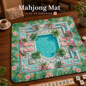 May include: A square mahjong mat featuring a tropical pool scene with blue water, light blue lounge furniture, pink flowers, and green palm leaves. The mat displays the text Mahjong Mat PLAY IN PARADISE with a small pink flower icon at the top.