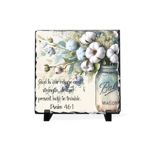 May include: A square decorative slate tile featuring a watercolor illustration of cotton flowers in a mason jar. The text "God is our refuge and strength, an ever-present help in trouble. Psalm 46:1" is also displayed.