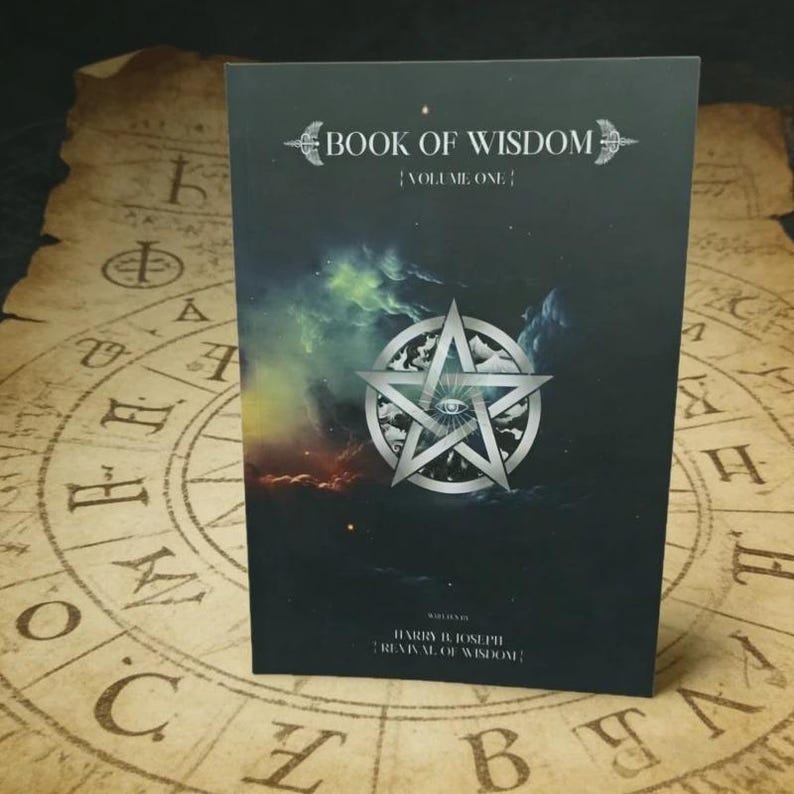 Puede incluir: Un libro negro titulado Book of Wisdom Volume One con un pentagrama plateado y un gr&aacute;fico de un ojo en la portada. La portada presenta un fondo tipo nebulosa con tonos verdes, azules y naranjas. El texto Harry B. Joseph Revival of Wisdom est&aacute; impreso.