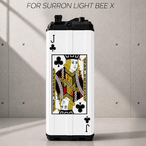 May include: A white battery sticker for a Surron Light Bee X featuring a Jack of Clubs playing card design. The graphic displays the classic court card illustration in red, black, and yellow. The text BATTERY STICKERS FOR SURRON LIGHT BEE X is visible.