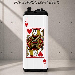 May include: A white battery sticker for a Surron Light Bee X electric bike, featuring a large Jack of Hearts playing card graphic in red, black, and yellow. The rectangular sticker has a black top and bottom edge and displays the text BATTERY STICKERS FOR SURRON LIGHT BEE X.
