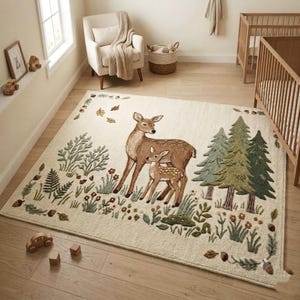 Hand tufted woodland rug featuring a mother deer and spotted fawn surrounded by pine trees, wildflowers, acorns, and botanical leaves on a cream background. Displayed in a natural wood Scandinavian nursery with a white armchair and wooden crib. Perfect as a baby nursery rug, boho living room rug, or unique baby shower gift. Made from premium wool in forest green, warm brown, and sage tones.