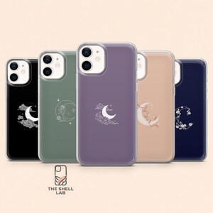 May include: Five smartphone cases in black, sage green, purple, beige, and navy blue. Each case features a white line art graphic of a crescent moon with celestial elements like clouds, stars, or floral vines. The text THE SHELL LAB is below.