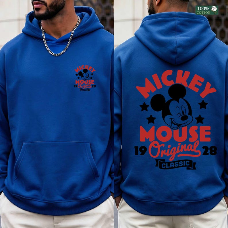 May include: A royal blue hoodie featuring a front and back graphic of Mickey Mouse. The front graphic includes the text "Mickey Mouse 19 Original 28". The back graphic has a larger Mickey Mouse design with the text "Mickey Mouse 19 Original 28 Classic".