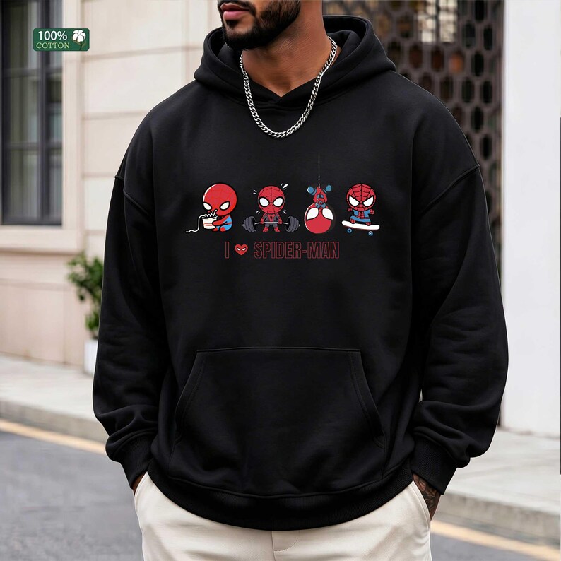 May include: A black hooded sweatshirt featuring a graphic print of four small Spider-Man characters performing different activities, including eating, lifting weights, hanging, and skateboarding, with the text I heart SPIDER-MAN below them.