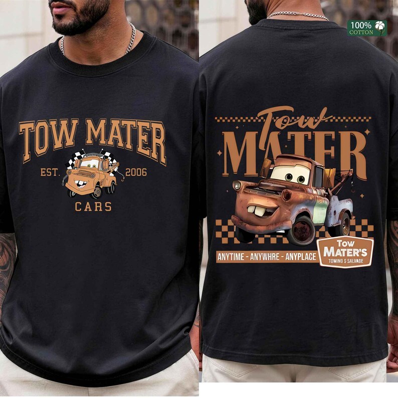 May include: A black t-shirt featuring a graphic of the character Tow Mater. The front displays the text Tow Mater Est. 2006 Cars. The back shows a larger illustration of the character with the text Tow Mater Anytime Anywhere Anyplace.