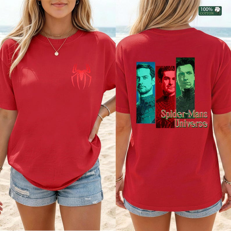 May include: A red short-sleeved t-shirt featuring a small red spider logo on the front chest. The back displays three portraits of men in blue, red, and green frames with the text Spider-Mans Universe. A 100% cotton label is visible in the corner.