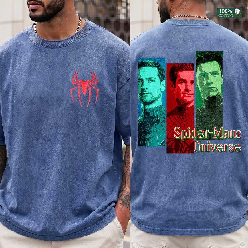 May include: A blue acid-wash t-shirt featuring a red spider logo on the front chest. The back displays three rectangular portraits of different characters in blue, red, and green tones, with the text Spider-Mans Universe printed below.
