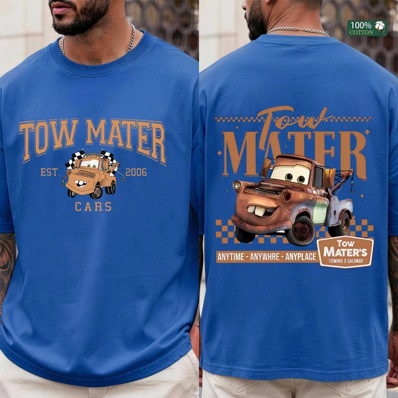 May include: A royal blue t-shirt featuring a graphic of the character Tow Mater. The front displays the text TOW MATER EST. 2006 CARS with a small truck illustration. The back features a larger truck graphic with the text TOW MATER ANYTIME ANYWHRE ANYPLACE.
