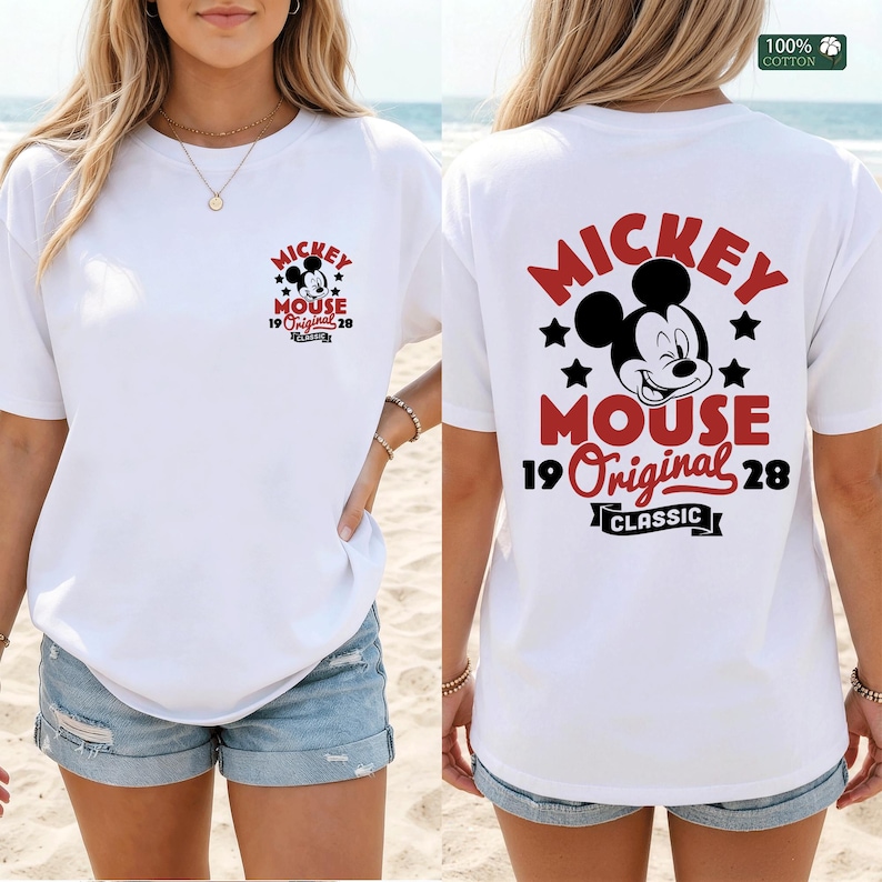 May include: White t-shirt featuring a Mickey Mouse graphic on the front and back. The front graphic includes Mickey's face, stars, and text. The back graphic is larger, with Mickey's face, stars, and the words "MICKEY MOUSE 19 Original 28 CLASSIC".