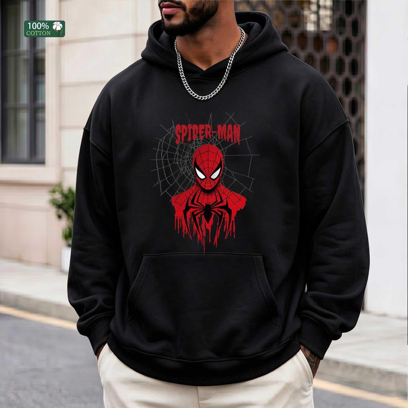 May include: Black hooded sweatshirt featuring a red Spider-Man graphic. The graphic includes the Spider-Man logo and a web design. The sweatshirt is made of 100% cotton.