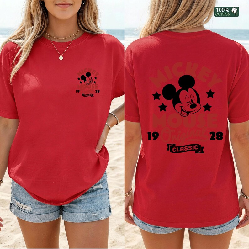 May include: Red t-shirt featuring Mickey Mouse graphics. The front displays a small Mickey Mouse design with text, while the back showcases a larger Mickey Mouse image with the text "Mickey Mouse Classic 1928". Made of 100% cotton.