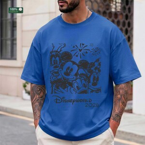 Puede incluir: Camiseta azul con un dise&ntilde;o negro de Mickey, Minnie, Donald y Goofy. El texto "Disneyworld 2020" est&aacute; impreso debajo. La camiseta es 100% algod&oacute;n.