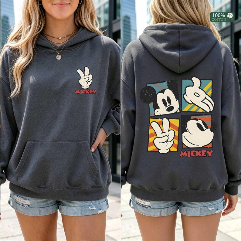 May include: Dark gray hoodie with a front pocket and a Mickey Mouse peace sign graphic. The back features a four-panel design with Mickey Mouse and his hands. The word "Mickey" is printed in red.