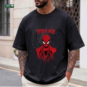 May include: Black t-shirt featuring a red and black Spider-Man graphic. The design includes the words "Spider-Man" above the character's face and a spider web background. Made of 100% cotton.