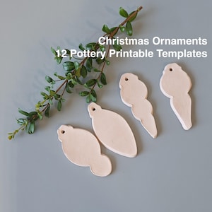May include: Four white ceramic Christmas ornament templates. The templates are shaped like a bell, a star, a tree, and a candy cane. The templates are on a light blue background. Christmas Ornaments 12 Pottery Printable Templates.