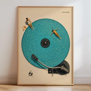 May include: A framed wall art print featuring a turquoise swimming pool shaped like a vinyl record. Two figures are in the water, one sitting on the edge and one floating. The design includes a record player tonearm and the text ENDLESS SUMMER.