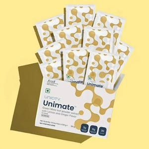 K&ouml;nnte beinhalten: Eine wei&szlig;e Schachtel und mehrere einzelne P&auml;ckchen mit Unicity Unimate Gr&uuml;nem Mate-Blatt-Pulverextrakt mit Zitronen- und Ingwergeschmack. Die Verpackung zeigt ein goldenes abstraktes Muster, den Text Unimate und 30 P&auml;ckchen &agrave; 6,30g.