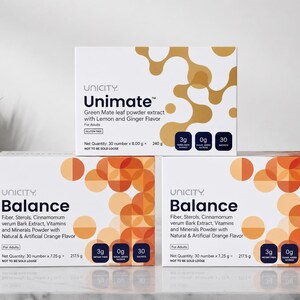 May include: Three white rectangular boxes of Unicity dietary supplements. One Unimate box features gold abstract shapes, while two Balance boxes display orange circular patterns. Each box lists ingredients, 3g fiber, 0g sugar, and 30 sachets.