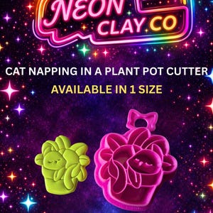 May include: Two plastic clay cutters in the shape of a cat napping in a plant pot. One is lime green, the other is magenta. The image includes the text "NEON CLAY.CO" and "CAT NAPPING IN A PLANT POT CUTTER".