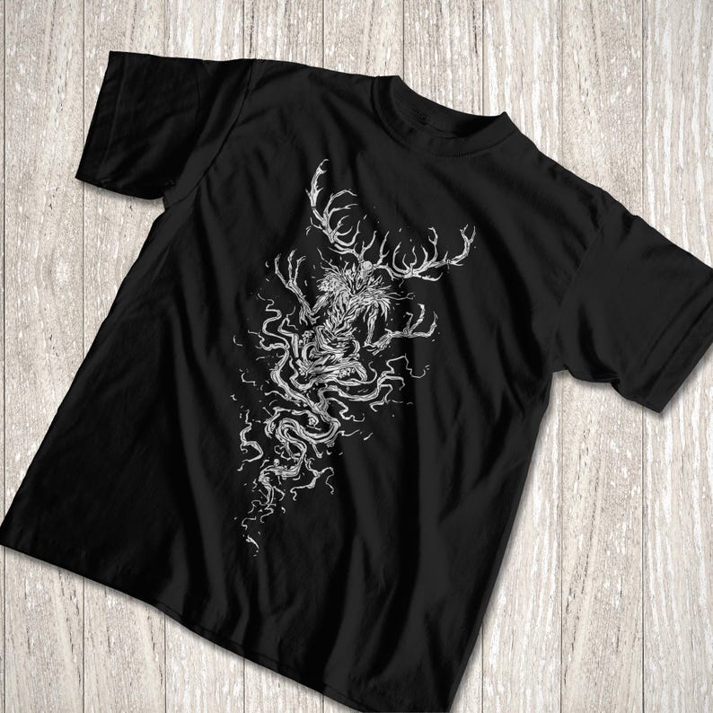 May include: A black short-sleeved t-shirt featuring a detailed white line art graphic of a creature with large antlers and elongated, branch-like limbs. The design extends downward in a swirling, root-like pattern across the center of the chest.